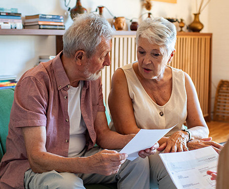 a senior couple reviewing paper documents