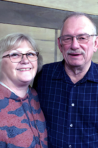 Mike and Ginney, smiling arm in arm